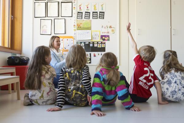 Children sitting in a row on the floor