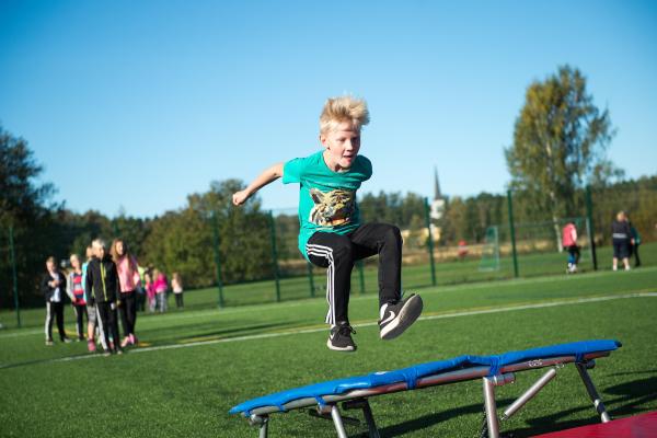 A boy bouncing on a trampoline