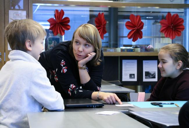 Kuvituskuva, opettaja näyttää neuvoo lasta
