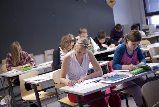 Students writing at their desks