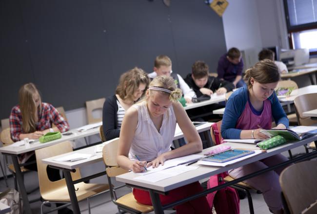 Students writing at their desks