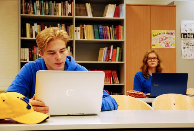 Upper secondary school students studying on their computers