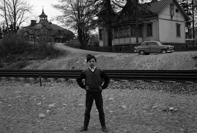 Romanipoika seisoo kotitalonsa edessä Helsingissä vuonna 1971