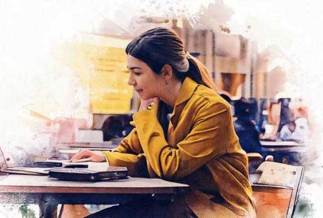 A picture of a young girl studying in a cafe.