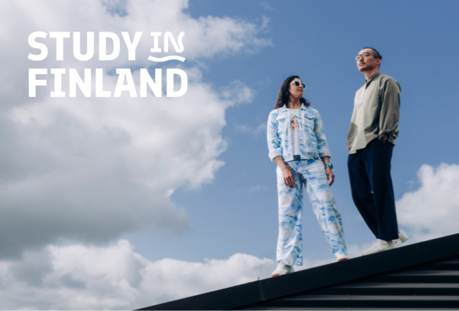 Study in Finland logo and two people standing on an elevated surface against a sky background