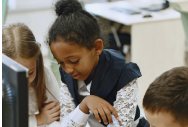 Picture of young people in front of computer