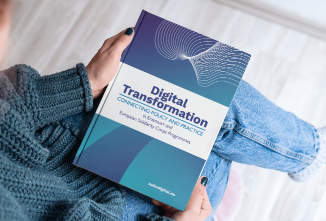 Picture of a person holding a book: Digital Transformation
