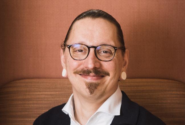 Image of a middle-aged man with glasses, moustasche, small beard, dark hair