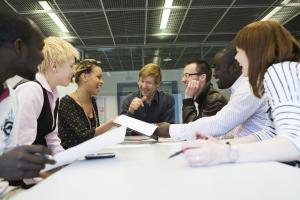 People sitting around a table in a meeting