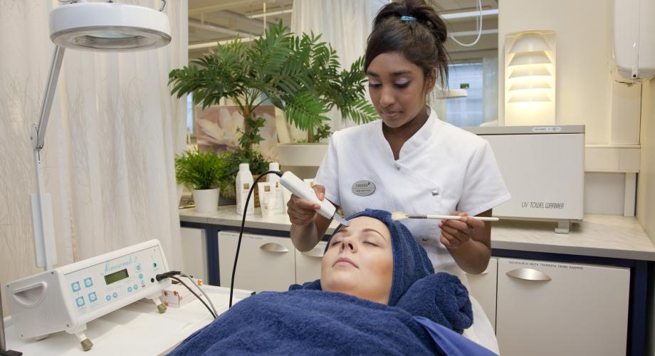 A woman being treated by a cosmetologist