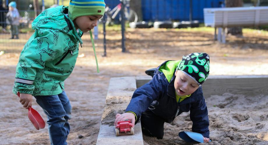 Lapset leikkivät hiekkalaatikolla