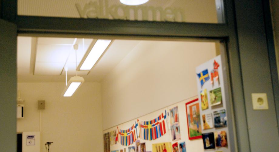 Picture of an open classroom door with the text "welcome"