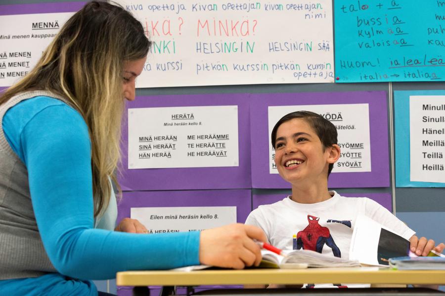 A teacher helping her pupil